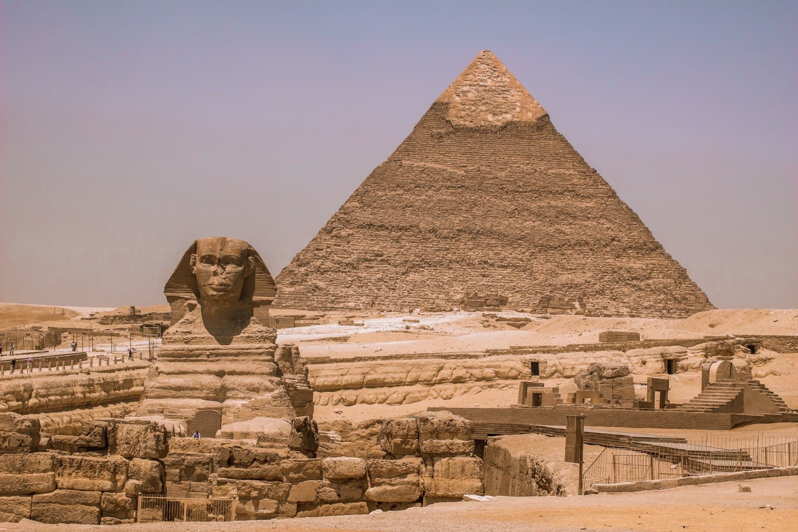 The Great Sphinx in front of a pyramid at Giza