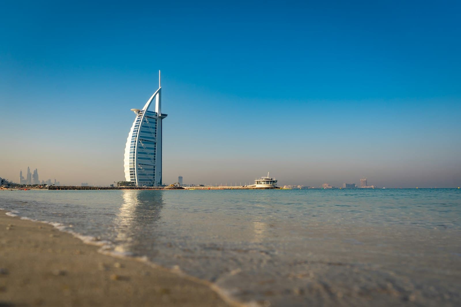 The Burj Al Arab rising from the sea beside a Dubai beach
