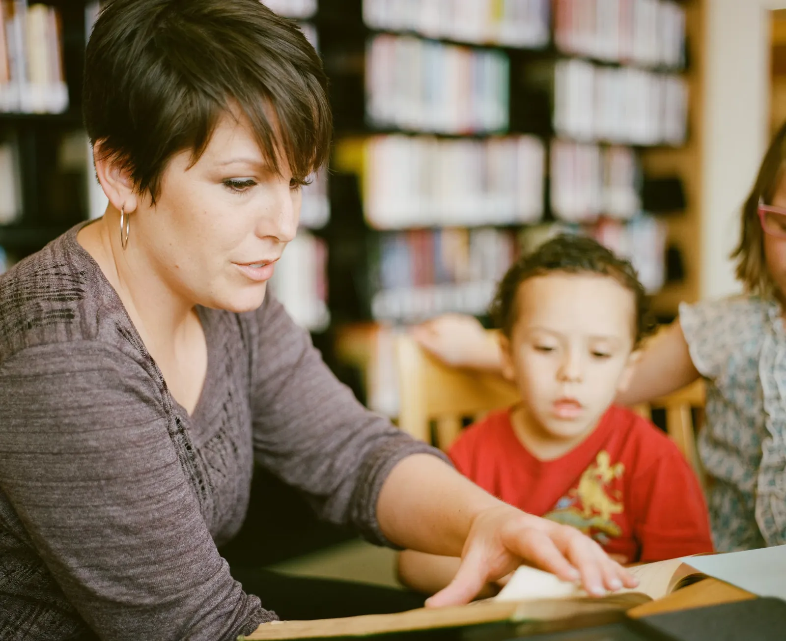 Transform primary school teacher helping a child with classwork after change management training