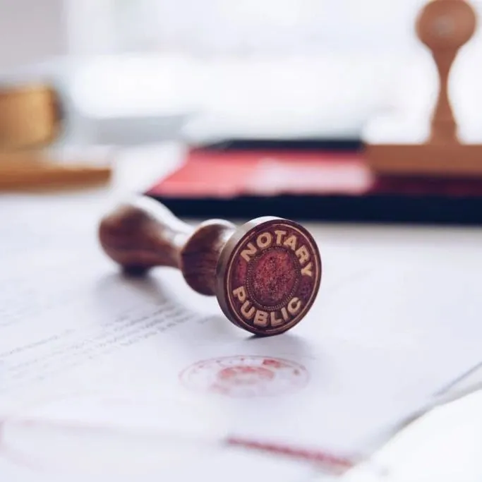 A close-up image of the underside of a notary stamp that reads "Notary Public."